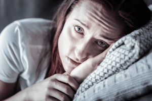 Person feeling signs of heroin withdrawal while lying in bed