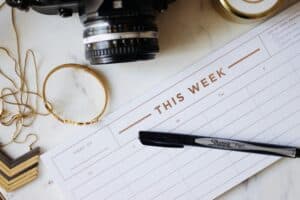 close up photo of ballpoint pen and planner showing a daily schedule for recovering addicts